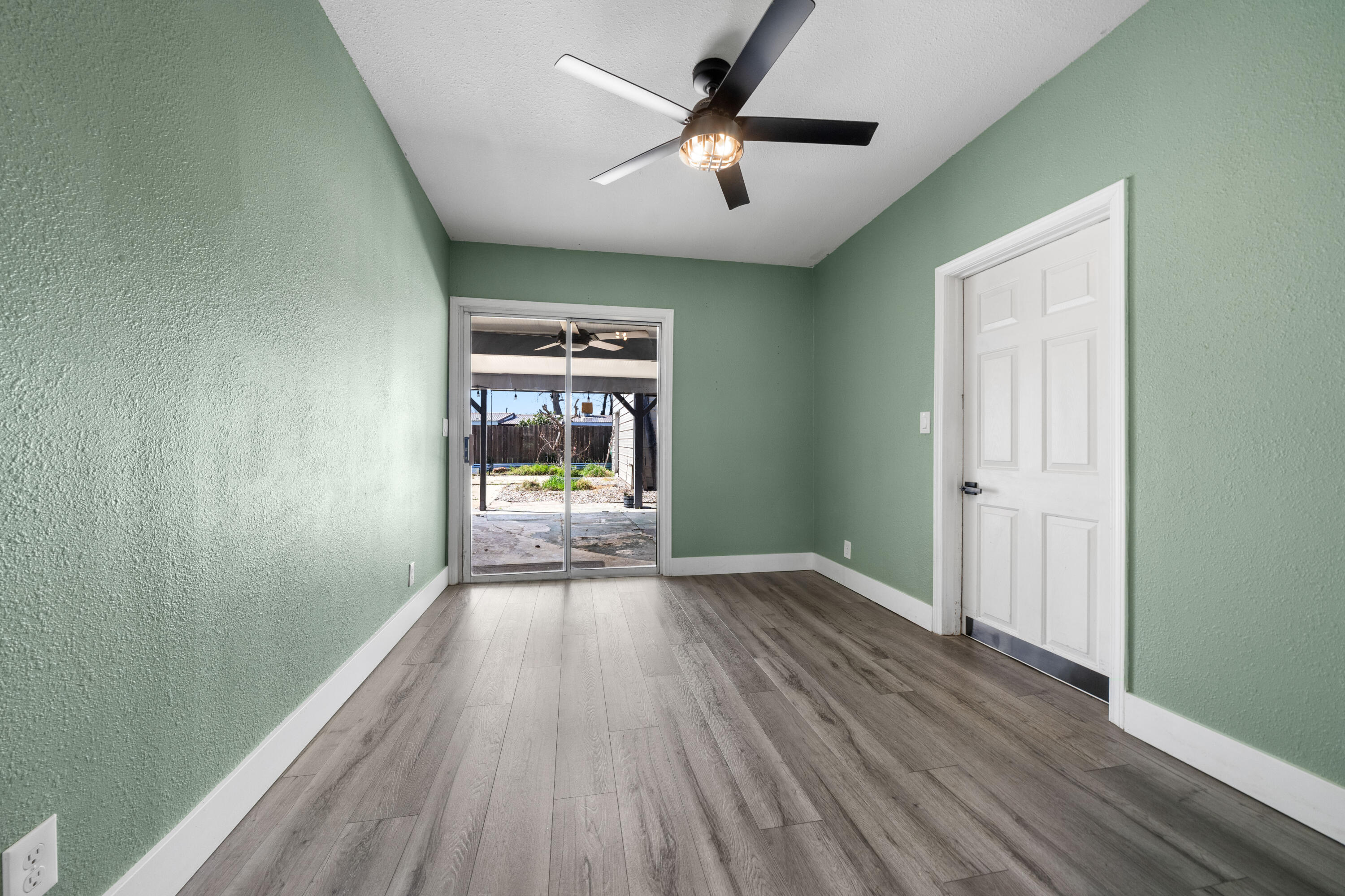 2648 Tremonto Road Anderson, CA 96007 - Photo 11 of 41 wooden floor in an empty room with a window
