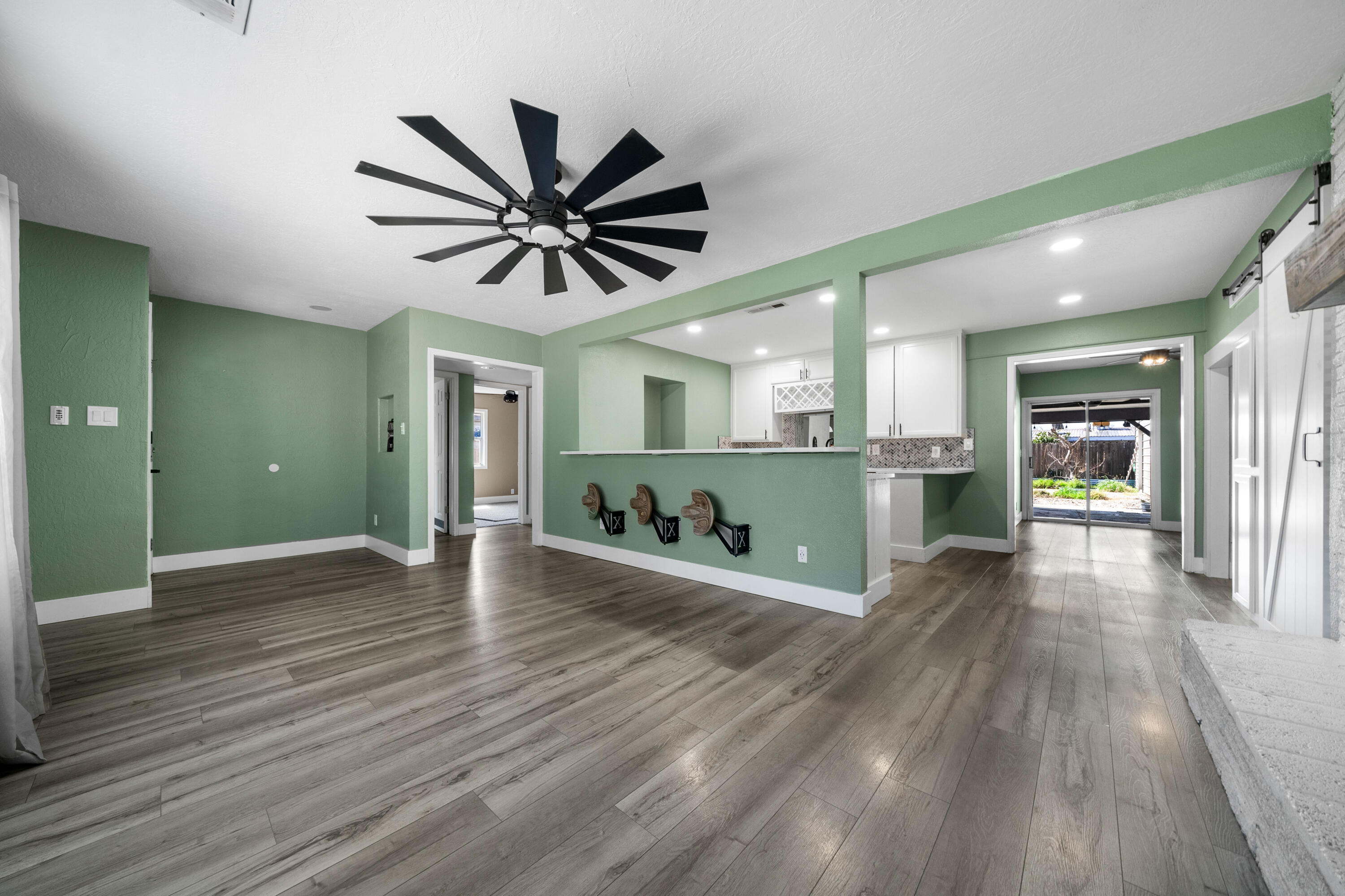 2648 Tremonto Road Anderson, CA 96007 - Photo 4 of 41 a view of a big room with wooden floor and a kitchen