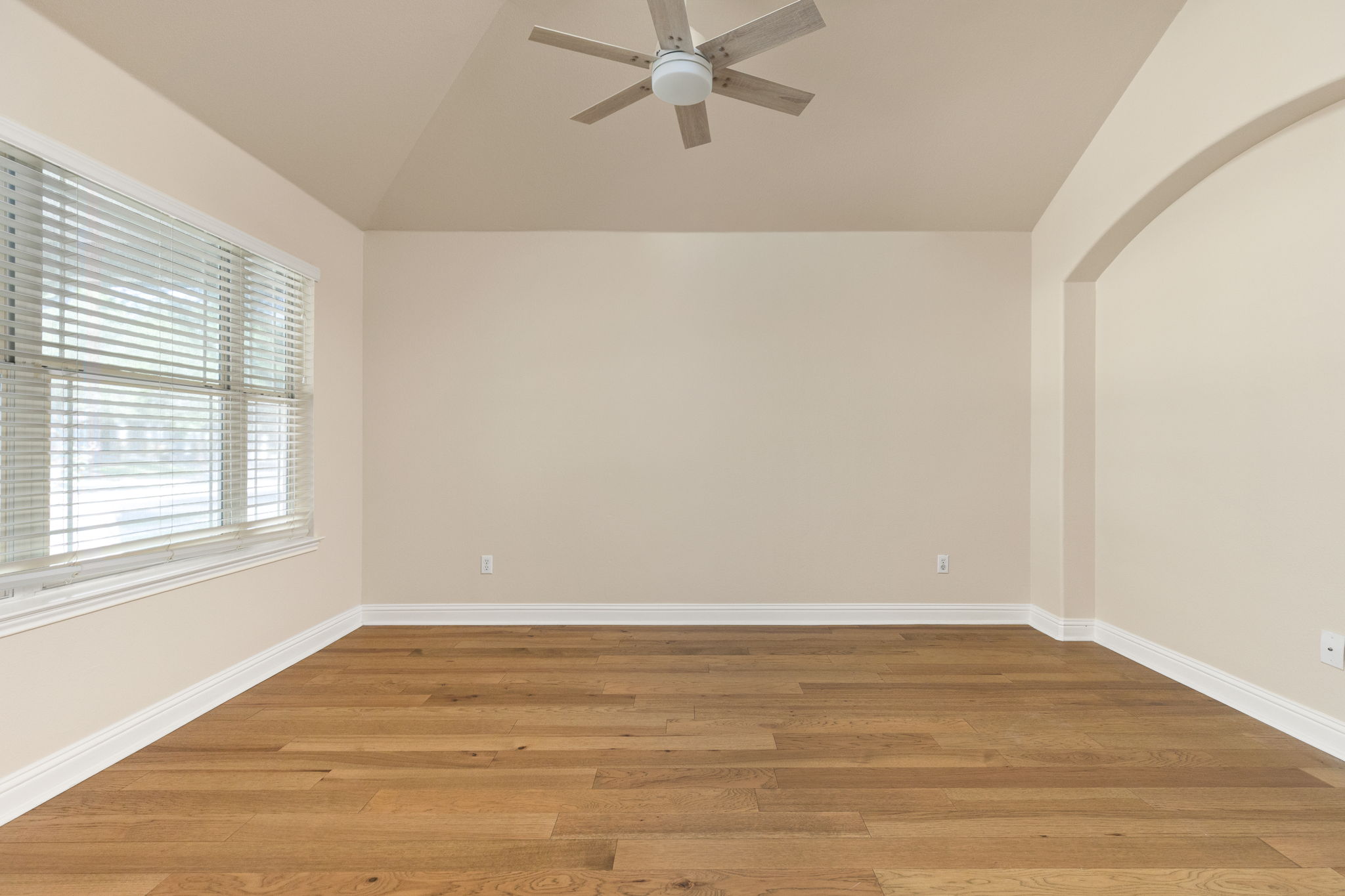 784 Sampson Kyle, TX 78640 - Photo 9 of 40 Gleaming hardwood floors and a tray ceiling define this versatile empty room.