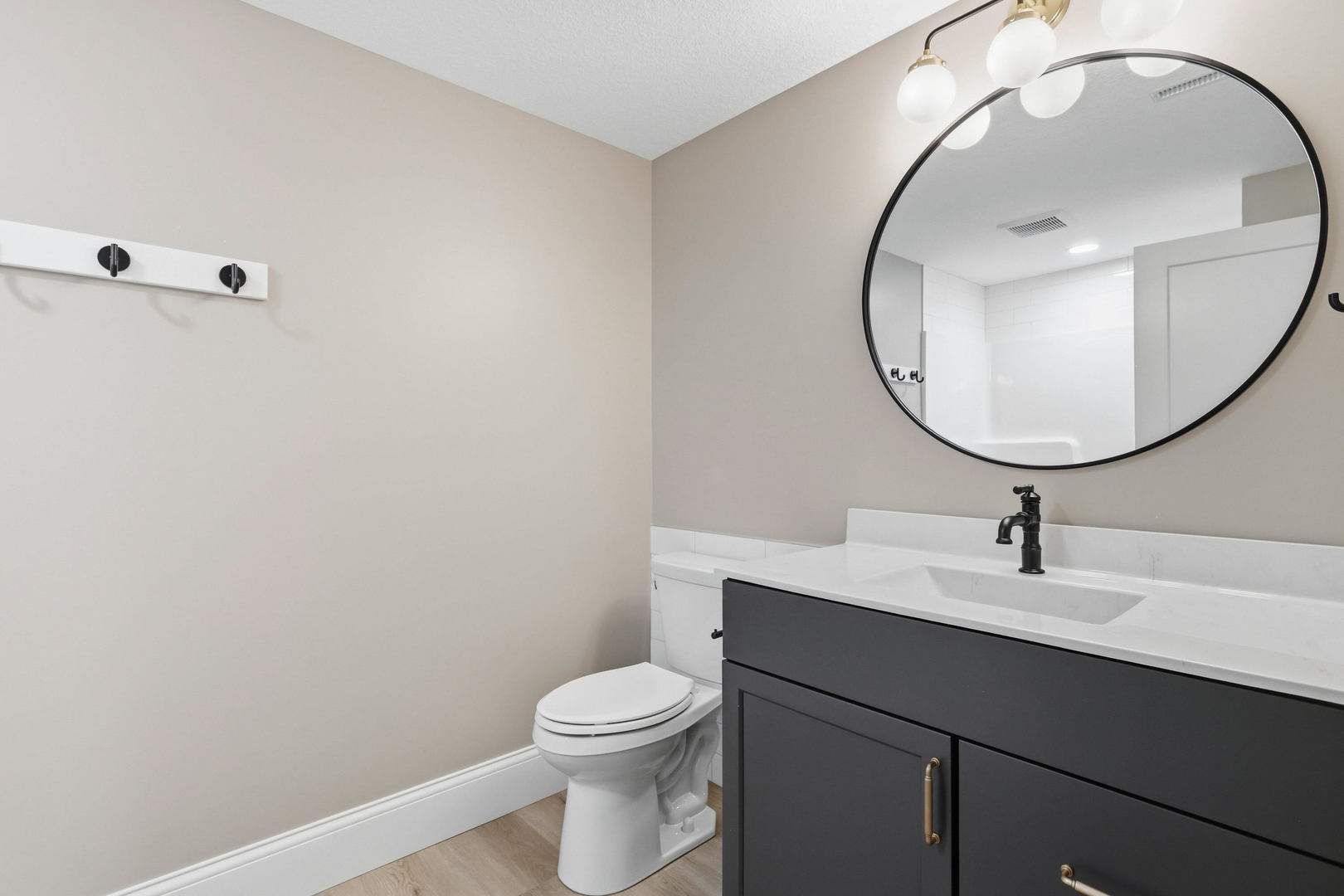 6928 Wilderness Pointe Bettendorf, IA 52722 - Photo 47 of 48 a bathroom with a sink a mirror and a toilet