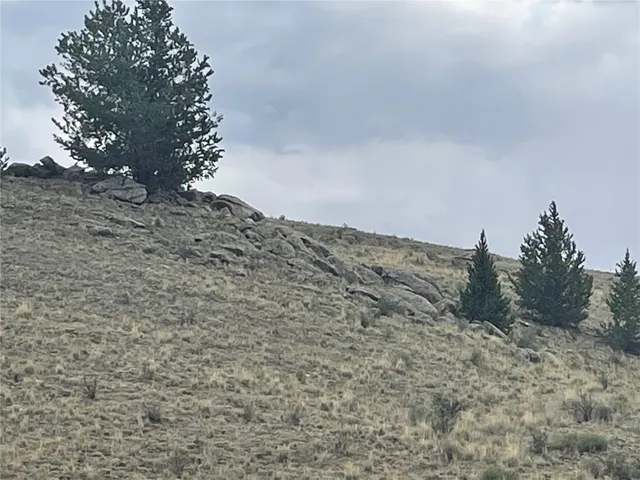 a view of dirt field and mountain view