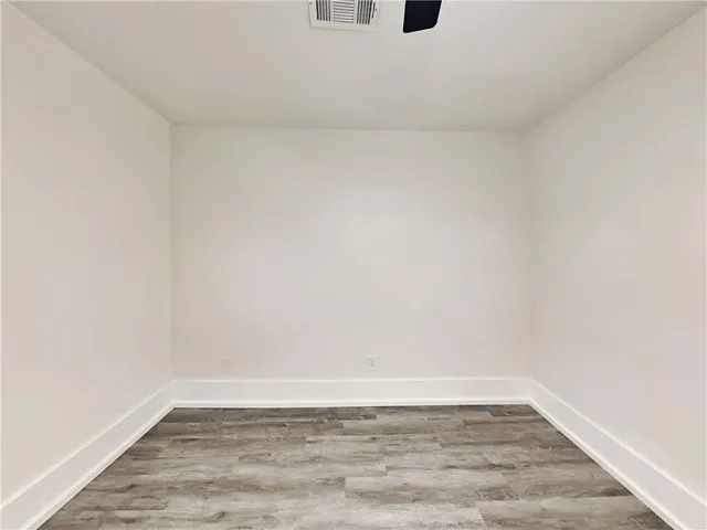 a view of an empty room and wooden floor