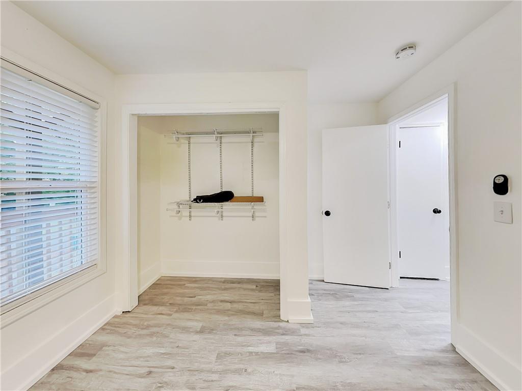 4013 Hawthorne Circle, Unit 2 Smyrna, GA 30080 - Photo 14 of 18 a view of a hallway with wooden floor and a bathroom