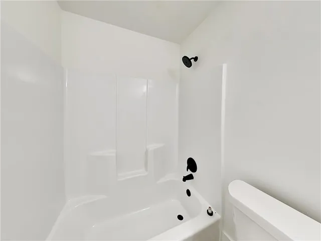 a bathroom with a bathtub and toilet