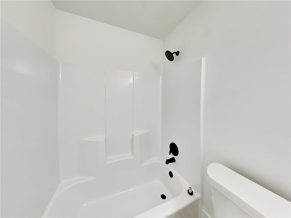4013 Hawthorne Circle, Unit 2 Smyrna, GA 30080 - Photo 15 of 18 a bathroom with a bathtub and toilet