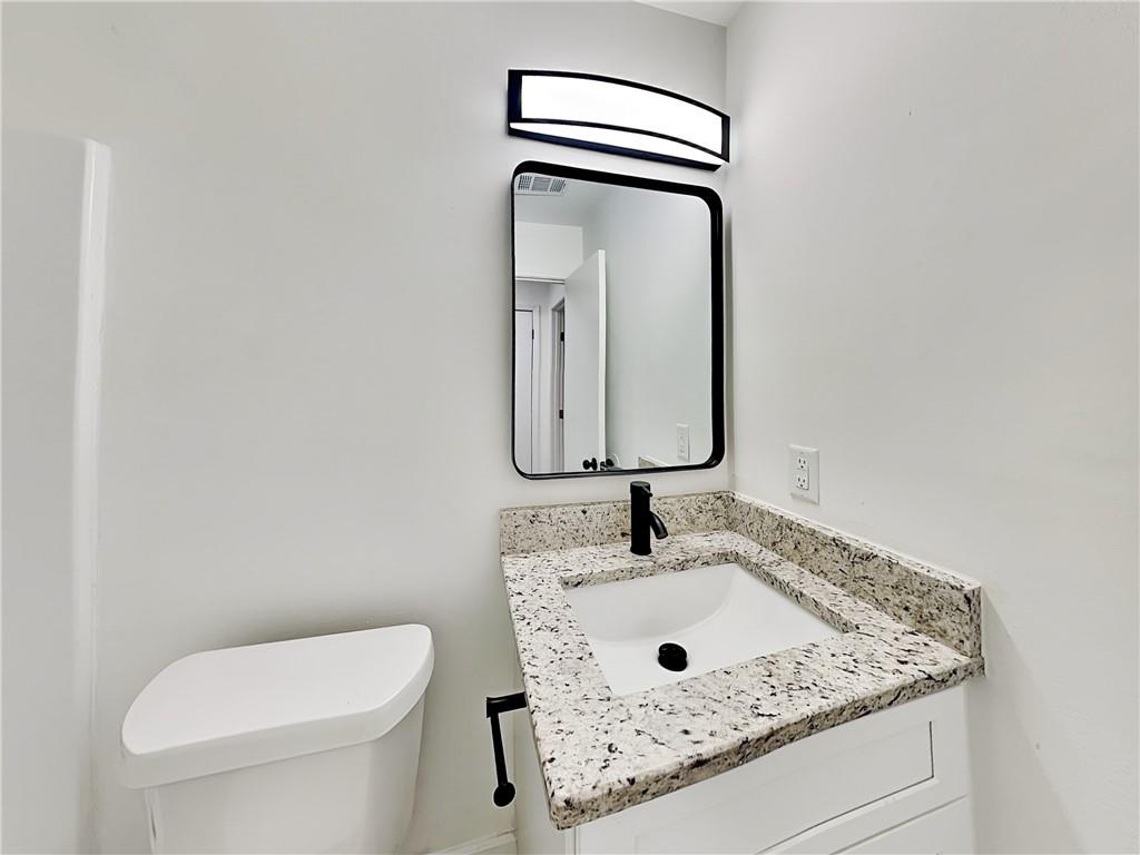 4013 Hawthorne Circle, Unit 2 Smyrna, GA 30080 - Photo 16 of 18 a bathroom with a toilet sink and mirror