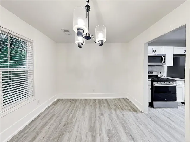 a view of a kitchen with a sink wooden floor and a window