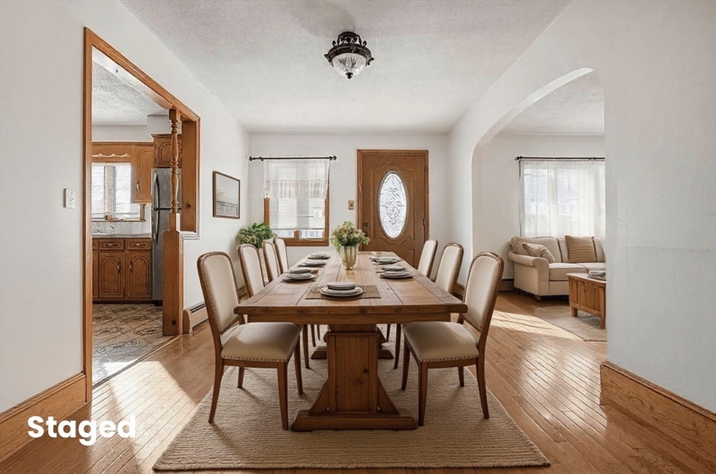 a view of a dining room with furniture window and wooden floor