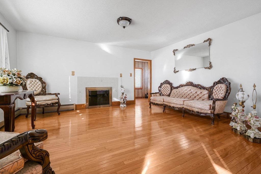 256 Rhode Island Avenue Fall River, MA 02724 - Photo 12 of 36 a living room with furniture and a fireplace