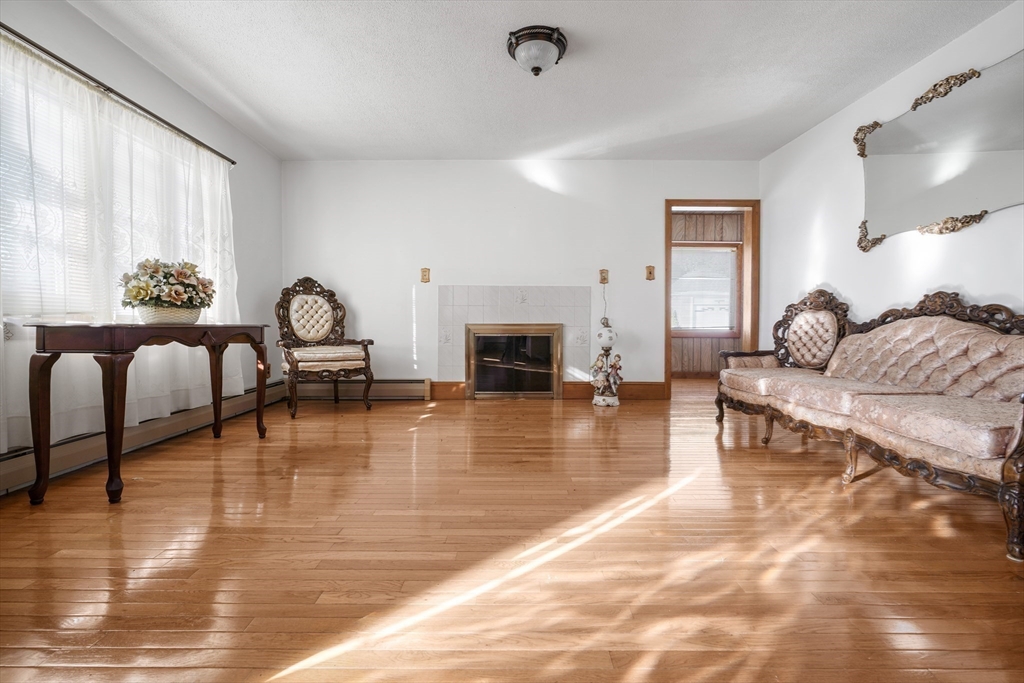256 Rhode Island Avenue Fall River, MA 02724 - Photo 16 of 36 a living room with furniture and a fireplace