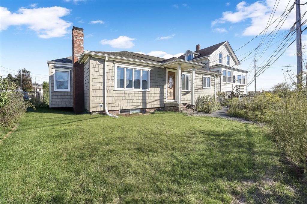 256 Rhode Island Avenue Fall River, MA 02724 - Photo 2 of 36 a front view of a house with a yard