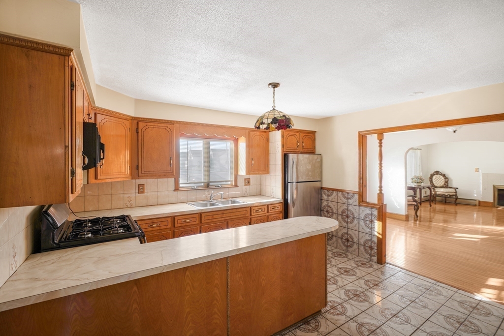 256 Rhode Island Avenue Fall River, MA 02724 - Photo 21 of 36 a large living room with stainless steel appliances granite countertop a couch and a view of living room