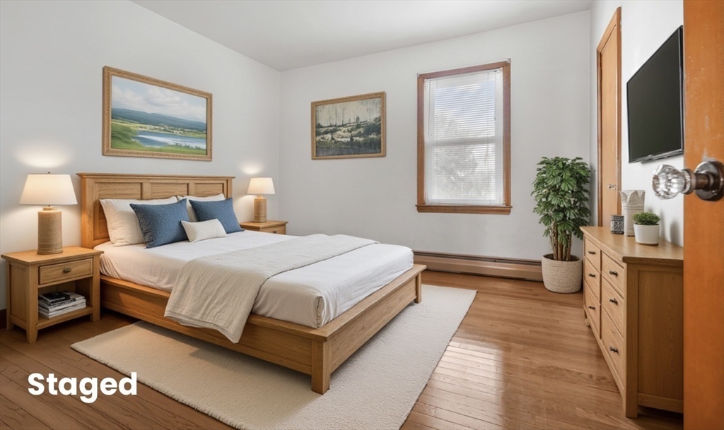 256 Rhode Island Avenue Fall River, MA 02724 - Photo 4 of 36 a spacious bedroom with a bed and a flat screen tv