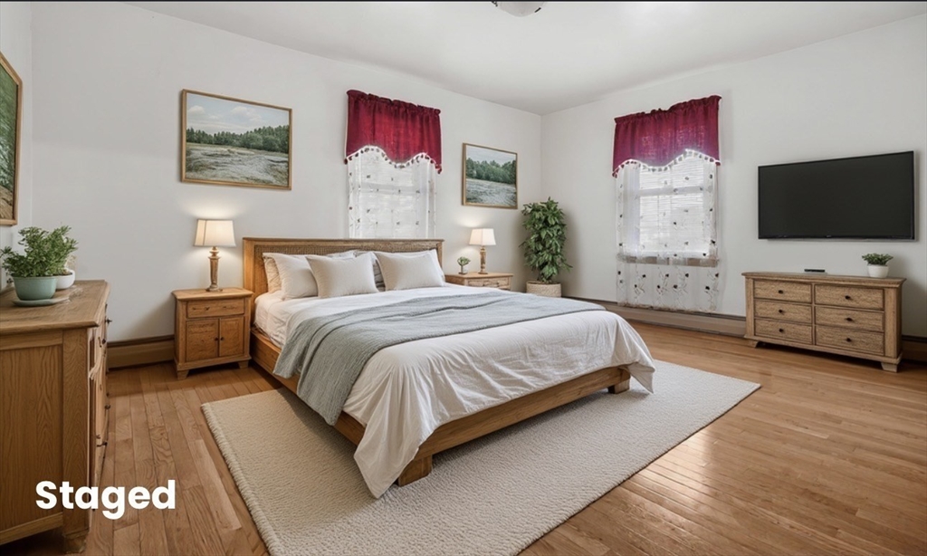 256 Rhode Island Avenue Fall River, MA 02724 - Photo 5 of 36 a bedroom with a bed and a flat screen tv