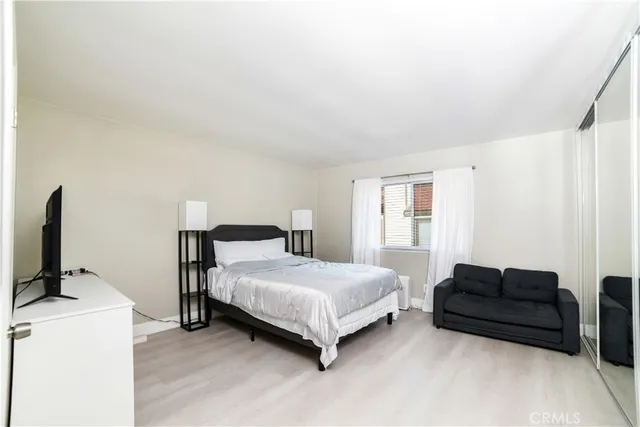 a bedroom with a bed and a flat screen tv