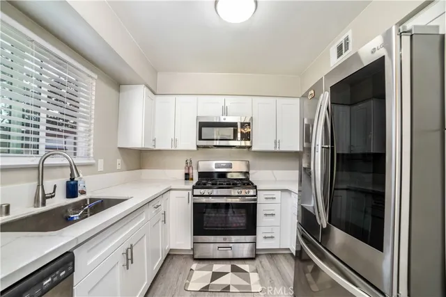 a kitchen with a refrigerator stove and sink