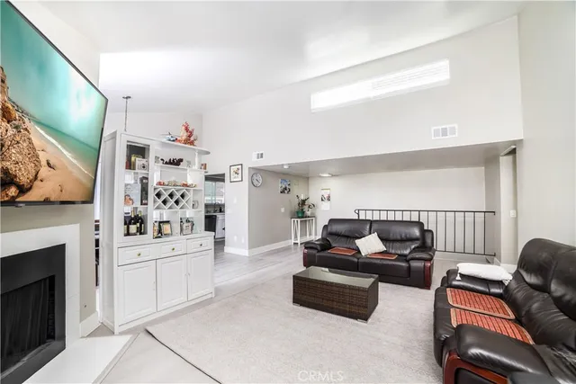 a living room with furniture cabinets and a fireplace