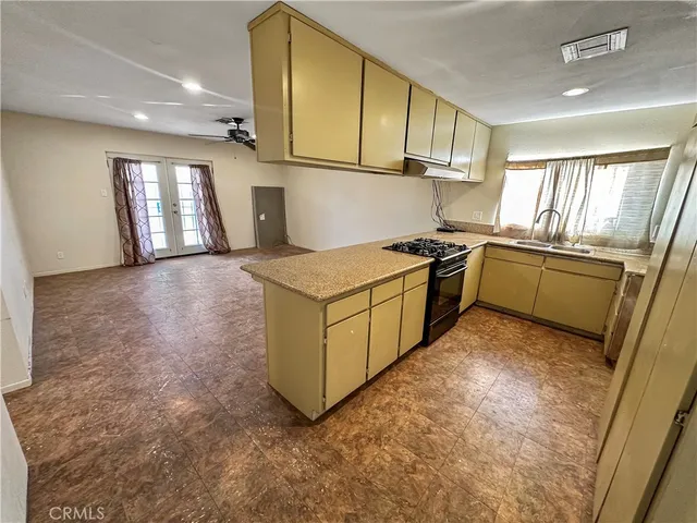 a kitchen with a stove a sink and a refrigerator