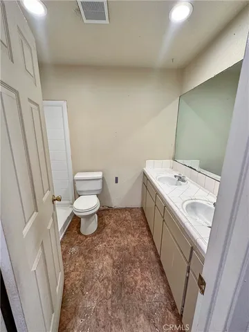 a bathroom with a sink a toilet and a mirror