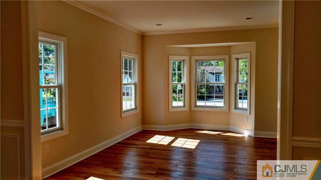 2028 Oak Tree Road Edison, NJ 08820 - Photo 2 of 39 a view of an empty room with wooden floor and a window