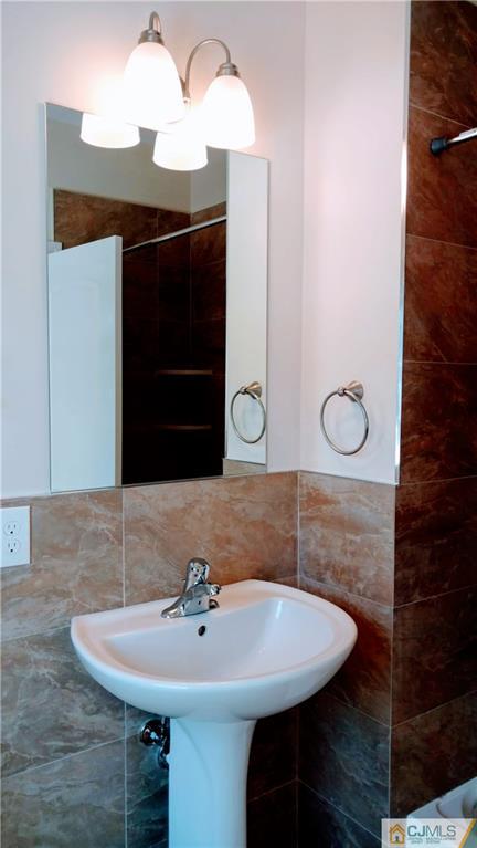 2028 Oak Tree Road Edison, NJ 08820 - Photo 13 of 39 a bathroom with a sink and a mirror