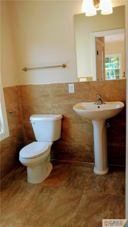 2028 Oak Tree Road Edison, NJ 08820 - Photo 14 of 39 a bathroom with a sink and a toilet