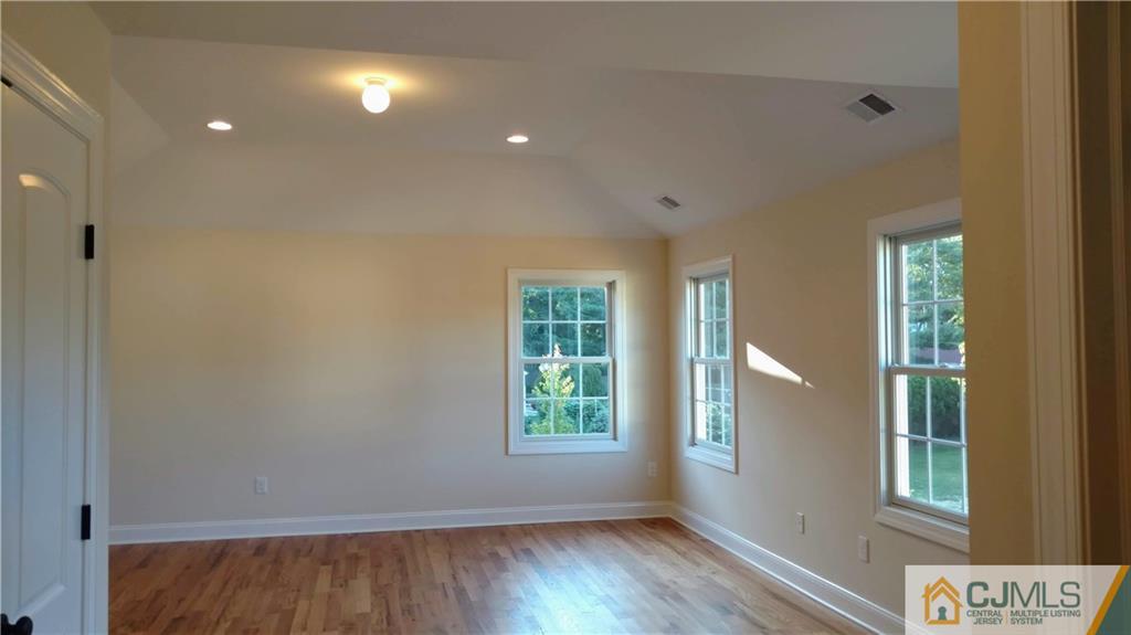 2028 Oak Tree Road Edison, NJ 08820 - Photo 18 of 39 a view of an empty room with wooden floor and a window