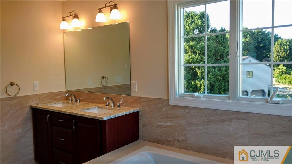 2028 Oak Tree Road Edison, NJ 08820 - Photo 19 of 39 a bathroom with a granite countertop sink and a mirror
