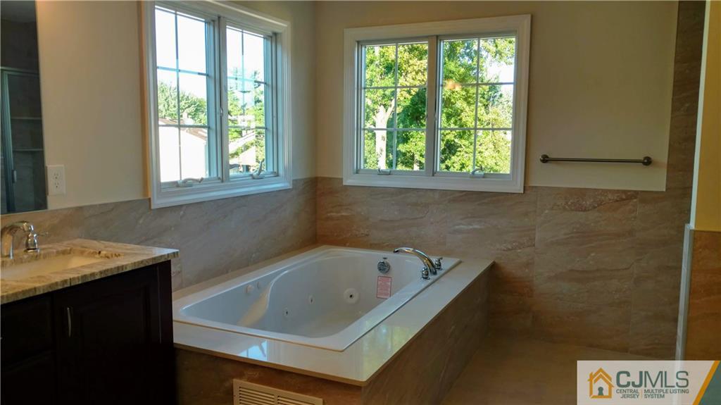 2028 Oak Tree Road Edison, NJ 08820 - Photo 20 of 39 a bathroom with a tub sink and window
