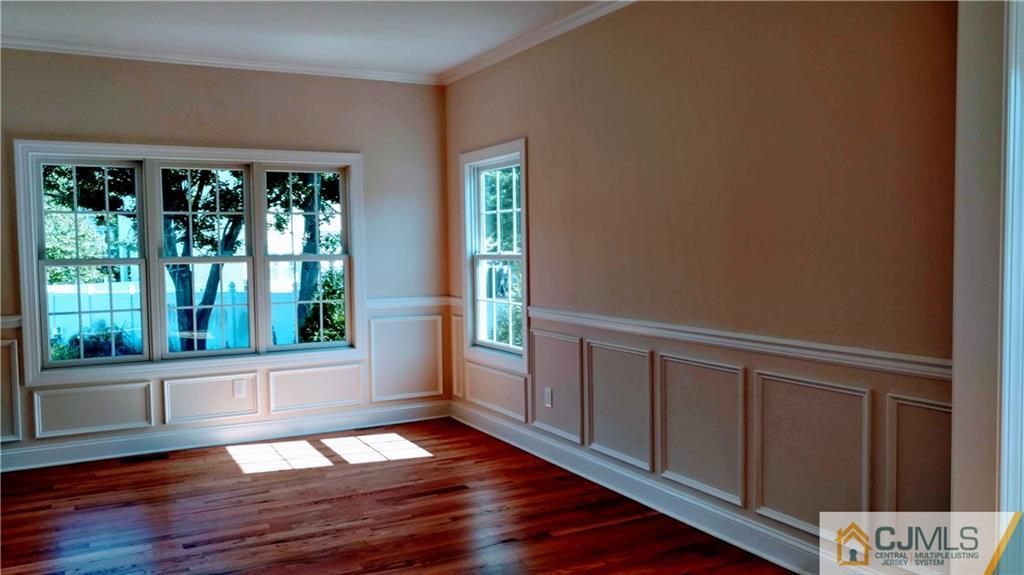 2028 Oak Tree Road Edison, NJ 08820 - Photo 3 of 39 a view of an empty room with wooden floor and a window