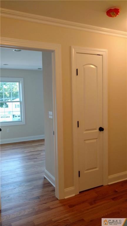 2028 Oak Tree Road Edison, NJ 08820 - Photo 27 of 39 a view of an empty room with wooden floor and a window