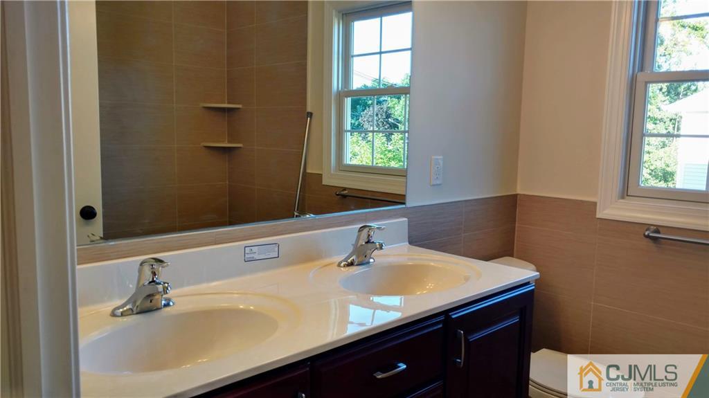 2028 Oak Tree Road Edison, NJ 08820 - Photo 28 of 39 a bathroom with a sink and a window