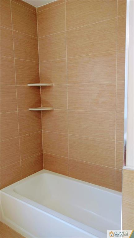 2028 Oak Tree Road Edison, NJ 08820 - Photo 30 of 39 a bathroom with a bathtub