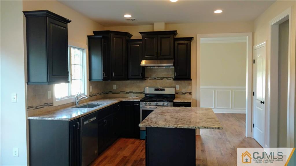 2028 Oak Tree Road Edison, NJ 08820 - Photo 4 of 39 a kitchen with a sink a stove a refrigerator and cabinets