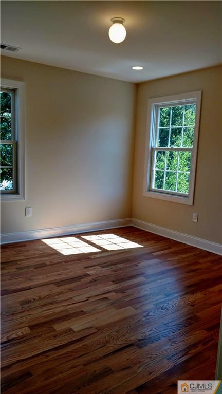 2028 Oak Tree Road Edison, NJ 08820 - Photo 32 of 39 a view of empty room with wooden floor and fan