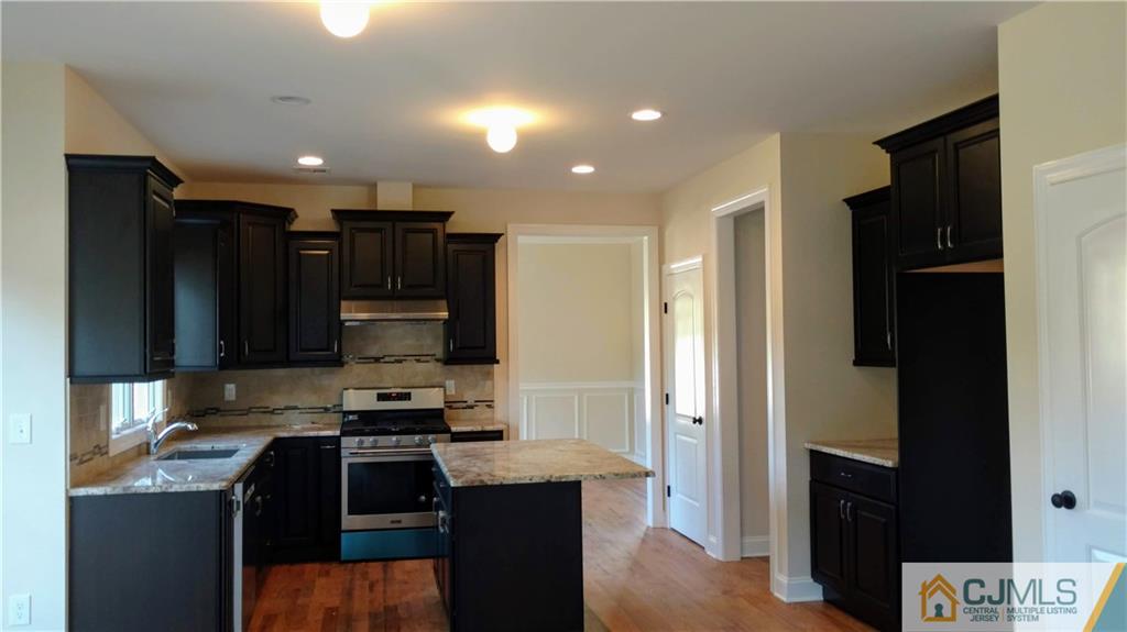 2028 Oak Tree Road Edison, NJ 08820 - Photo 6 of 39 a kitchen with stainless steel appliances granite countertop a refrigerator and a stove top oven