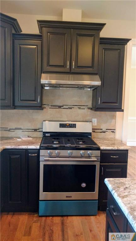 2028 Oak Tree Road Edison, NJ 08820 - Photo 7 of 39 a stove top oven sitting inside of a kitchen