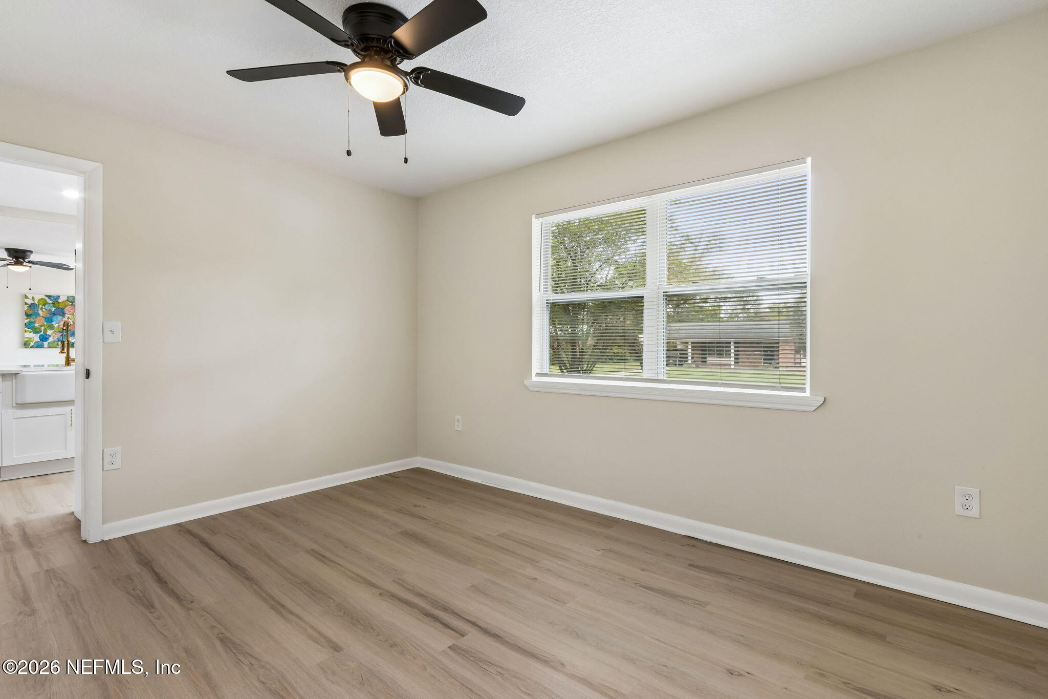3668 Marianna Road Jacksonville, FL 32217 - Photo 23 of 28 a view of empty room with wooden floor and ceiling fan