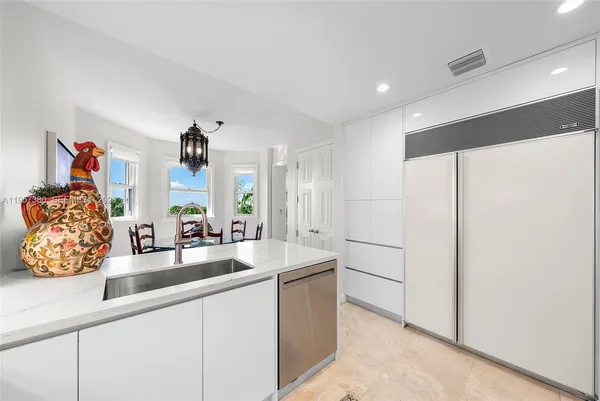 a view of a chairs and table in patio with a balcony