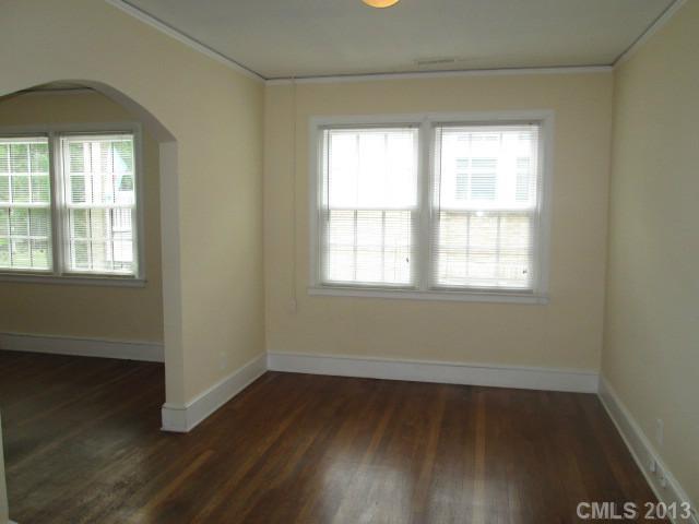 516 Grandin Road, Unit 3 Charlotte, NC 28208 - Photo 3 of 7 an empty room with wooden floor and windows