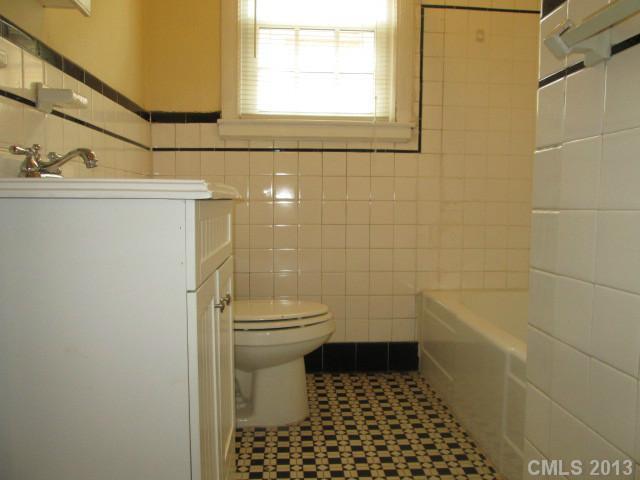 516 Grandin Road, Unit 3 Charlotte, NC 28208 - Photo 6 of 7 a bathroom with a toilet and a shower