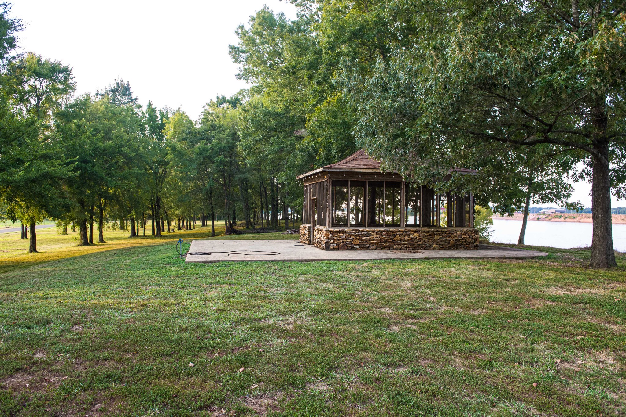 0 Leath Road Counce, TN 38326 - Photo 13 of 50 a view of a swimming pool with a table and chairs under an umbrella