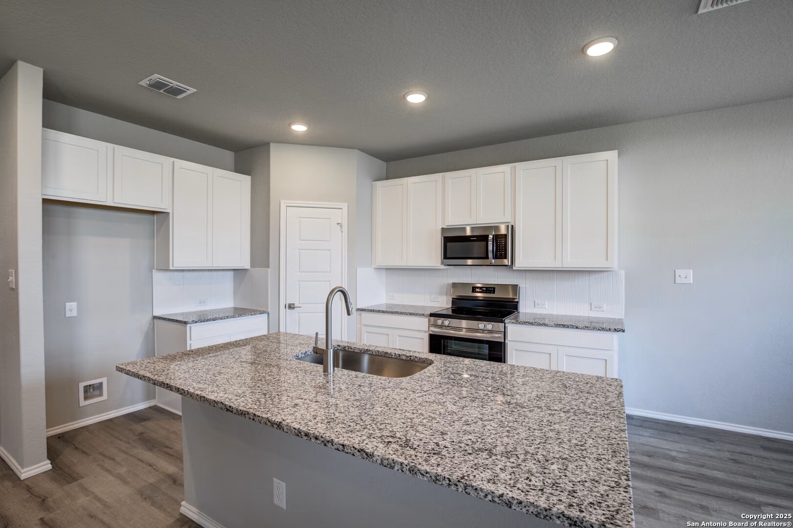 3453 Meteor Night Converse, TX 78109 - Photo 12 of 22 a kitchen with stainless steel appliances granite countertop a sink stove and refrigerator