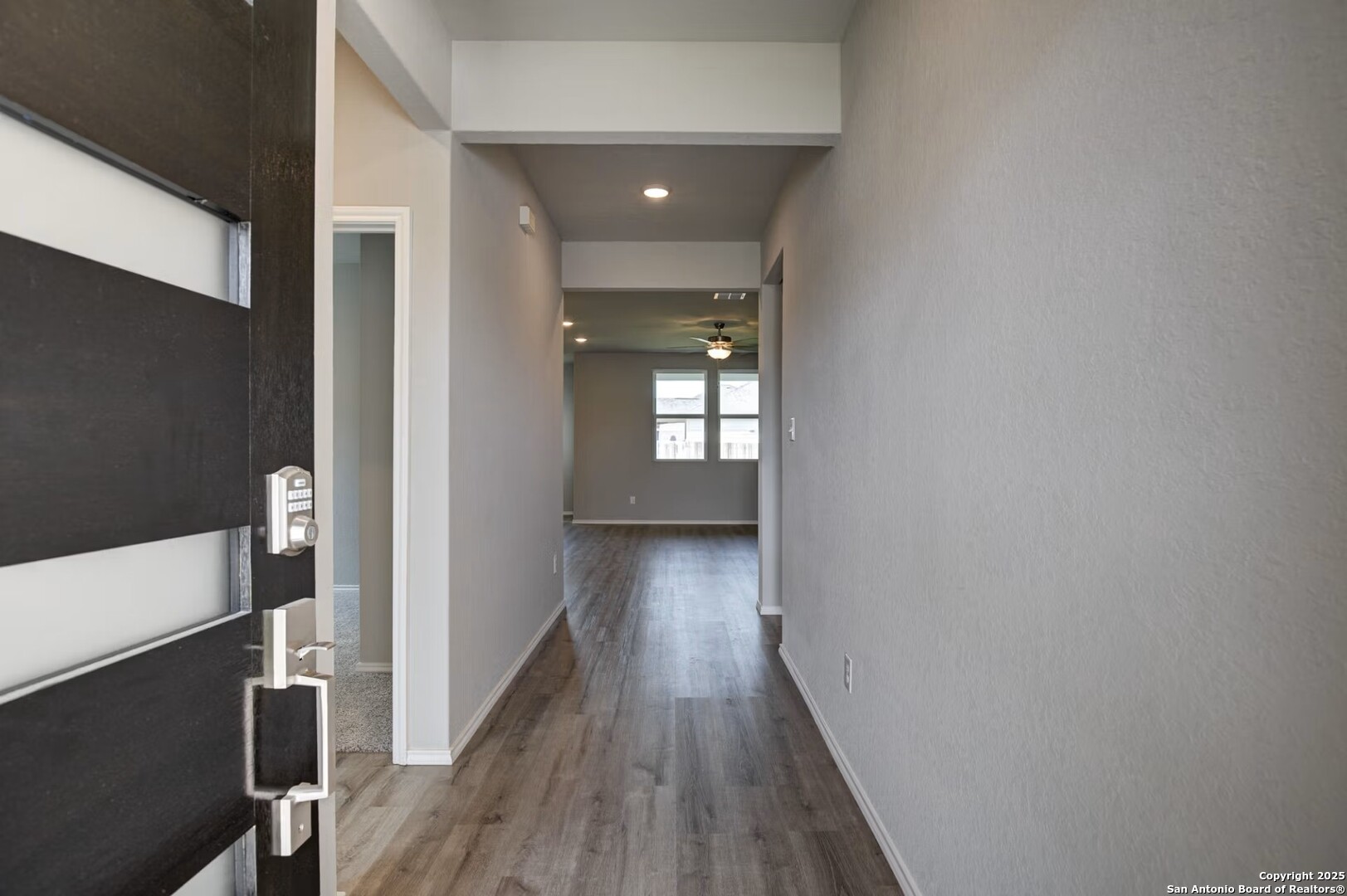 3453 Meteor Night Converse, TX 78109 - Photo 2 of 22 a view of a hallway with wooden floor and staircase