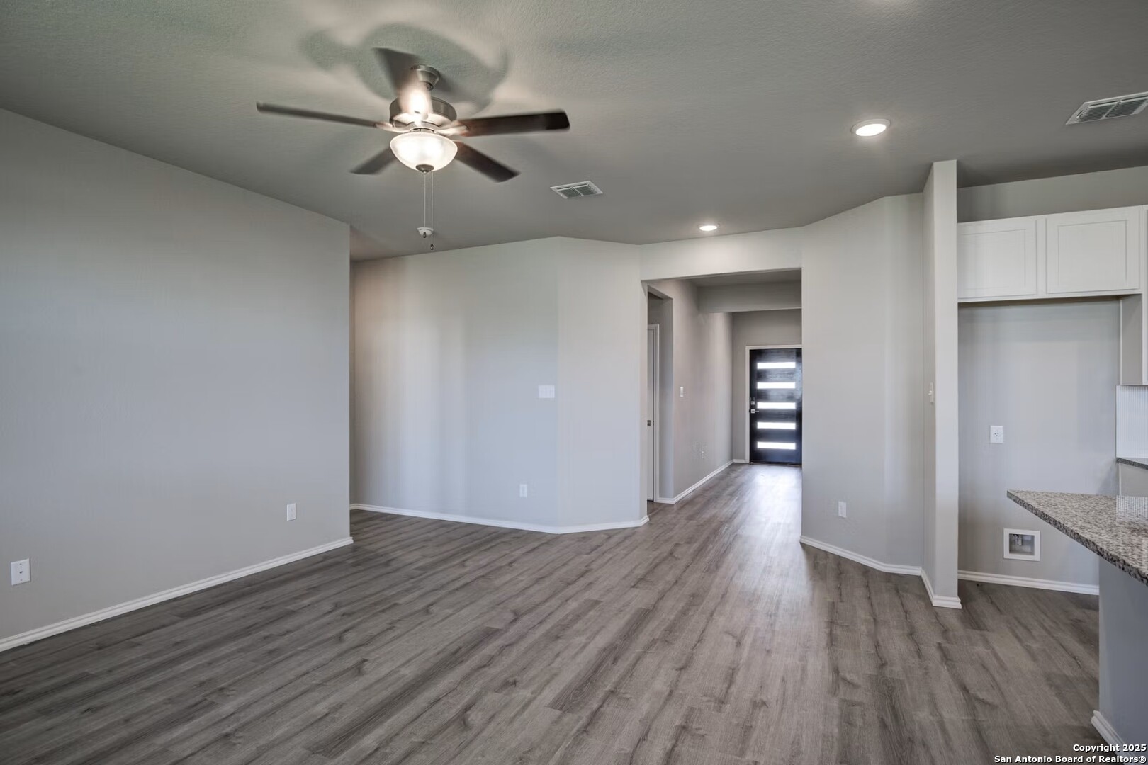 3453 Meteor Night Converse, TX 78109 - Photo 7 of 22 a view of an empty room with wooden floor and a ceiling fan