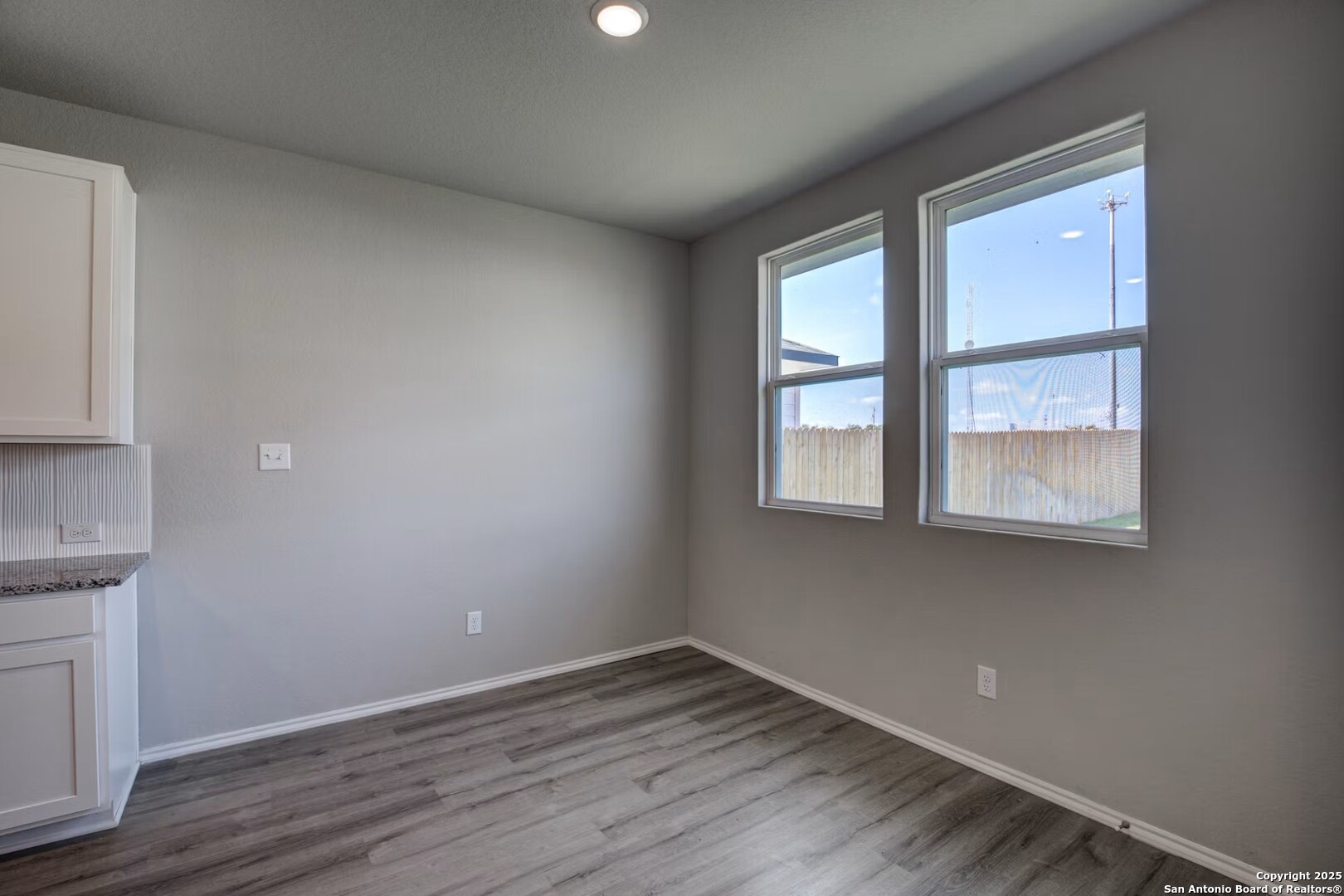 3453 Meteor Night Converse, TX 78109 - Photo 8 of 22 a view of an empty room with wooden floor and a window