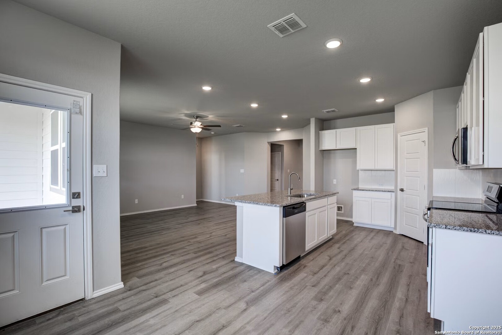 3453 Meteor Night Converse, TX 78109 - Photo 9 of 22 a kitchen with a refrigerator and white cabinets