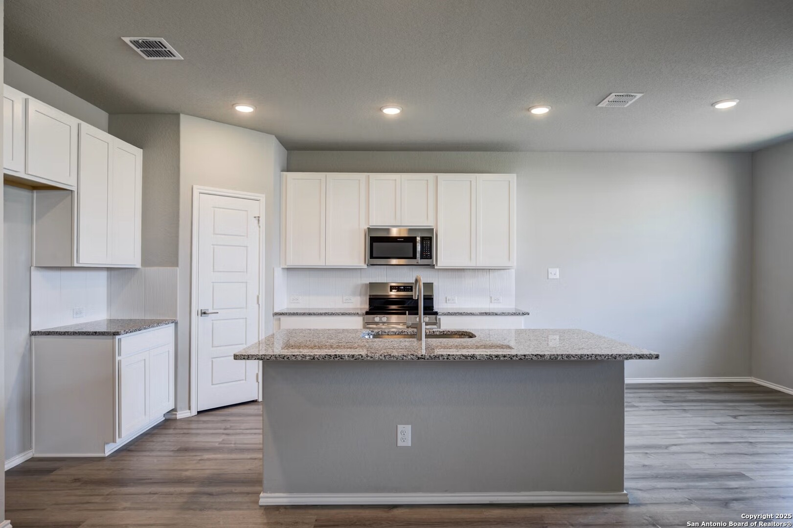 3453 Meteor Night Converse, TX 78109 - Photo 10 of 22 a kitchen with kitchen island a counter top space cabinets and stainless steel appliances