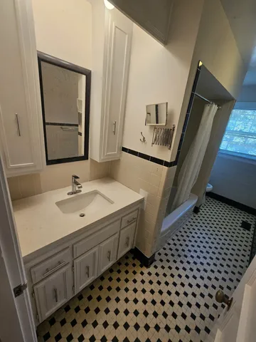 a bathroom with a sink a toilet a mirror and vanity
