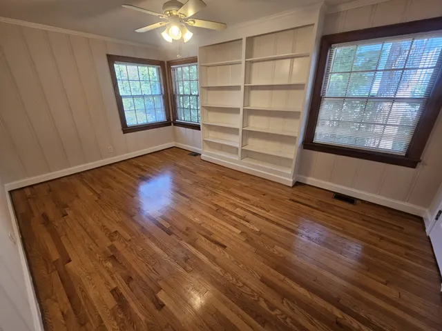 wooden floor in an empty room with a window